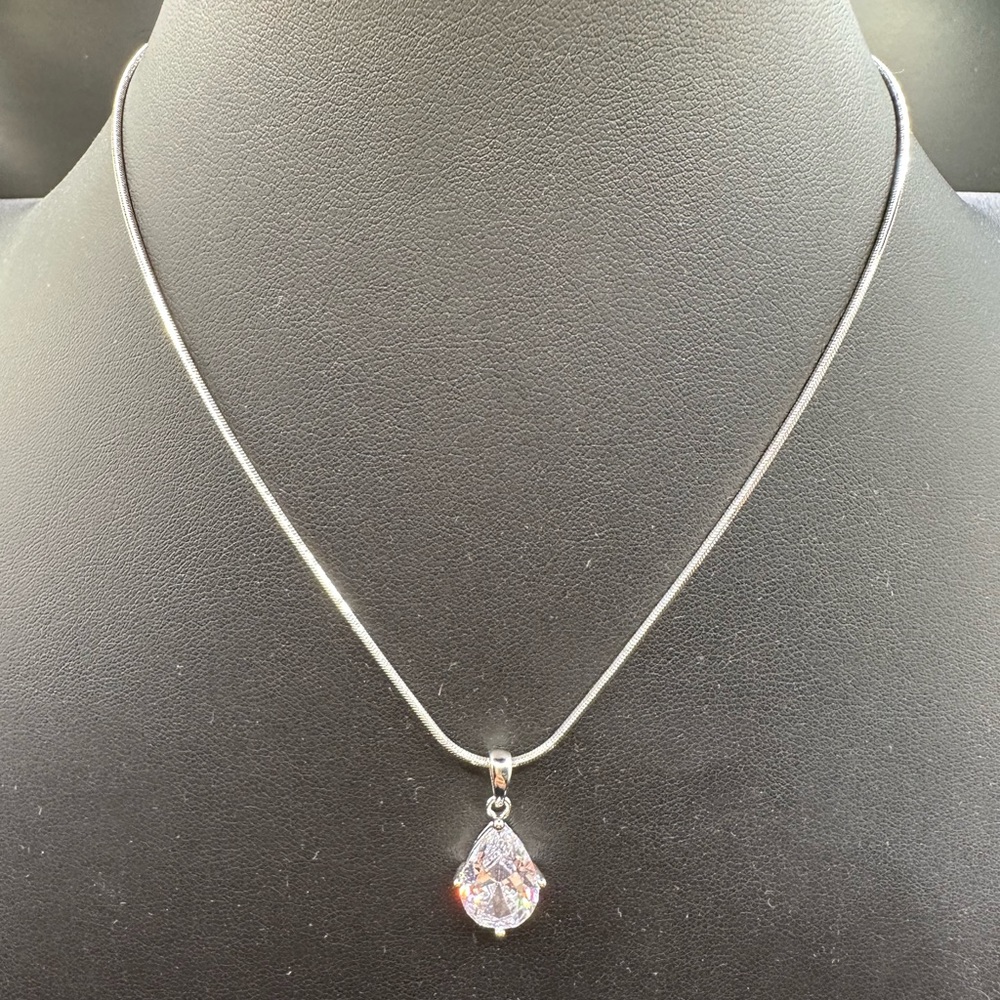Clear crystal teardrop on a silver chain.